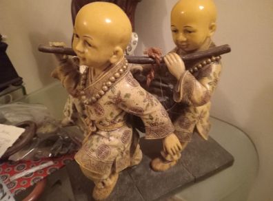 Asian Figure of Children carrying water-bucket.