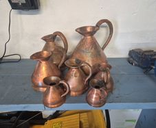 Set of 7 brass decorative jugs