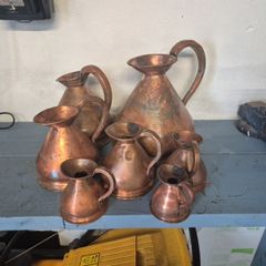 Set of 7 brass decorative jugs