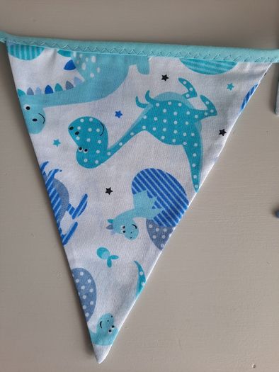 Dinosaur buntings . Blue and pink