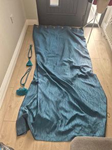 Pair of teal colured eyelet curtains