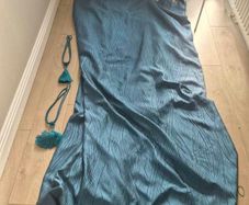 Pair of teal colured eyelet curtains
