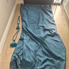 Pair of teal colured eyelet curtains