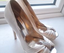 Ivory satin peetoe high heel shoes by Dune London with a pleated bow trim accented with rhinestones