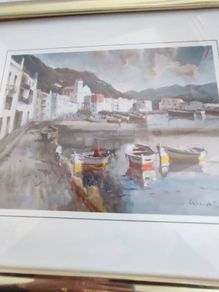 Framed signed print of sea side village.