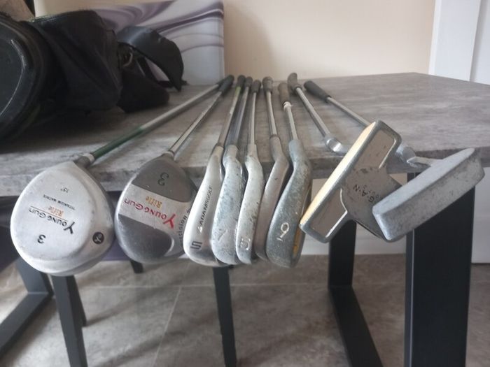 A selection of junior golf clubs and bag.