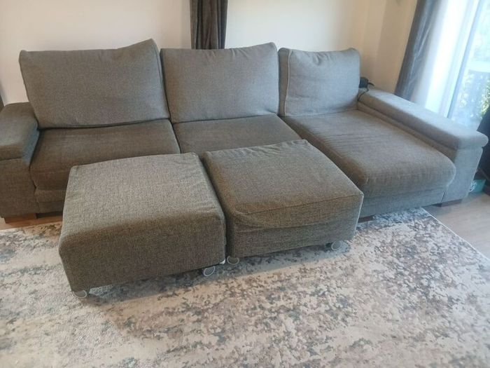 Grey L shaped corner sofa with 2 pouffes. Electric recline on long end