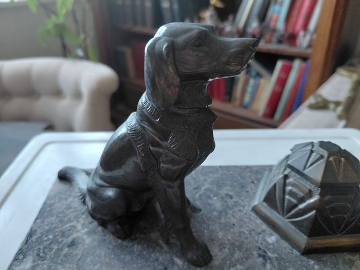 Antique desk inkwell with a seated dog on marble stand