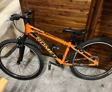 Romet Rambler hardtail mountain bike in orange.