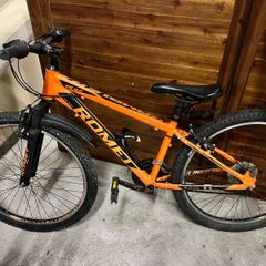 Romet Rambler hardtail mountain bike in orange.