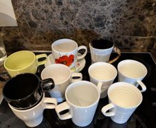 11 mugs and a plate