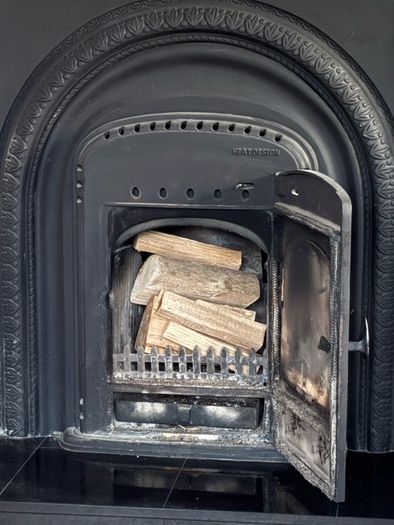 Marble fireplace surround and plinth with solid fuel stove