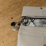 River Island clutch purse featuring a dual-texture gray flap panel design and a central dark metallic logo plate. Perfect inside. Image 7