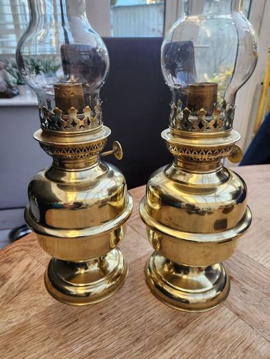 Matching pair of brass oil lamps.