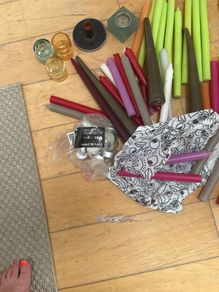 Large collection of  coloured candles and candle holders a few broken and few slightly used