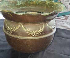 Antique Copper Jardiniere Planter, likely dating from around 1880s to 1920s. It features a distinctive scalloped, or frilled, edge rim. The body is adorned with embossed floral and swag designs.