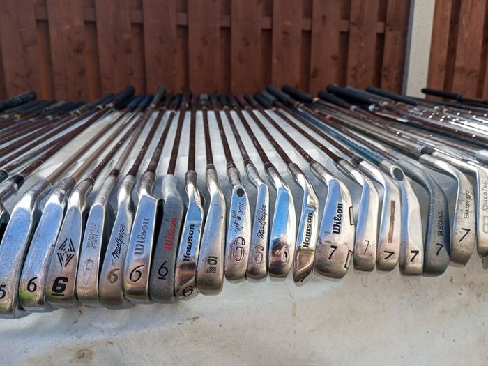 A selection of golf clubs and bags. All right handed clubs.