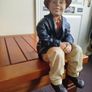 Resin sculpture of a seated boy Image 3