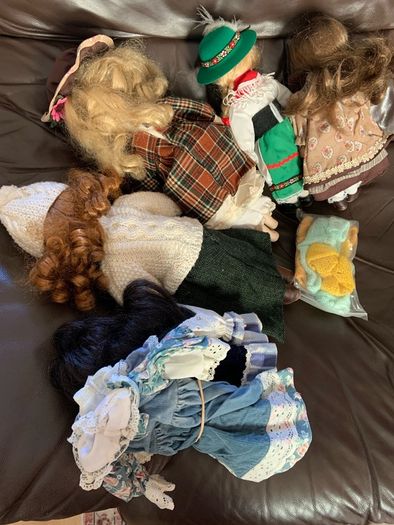 5 porcelain dolls with extra clothing perfect condition