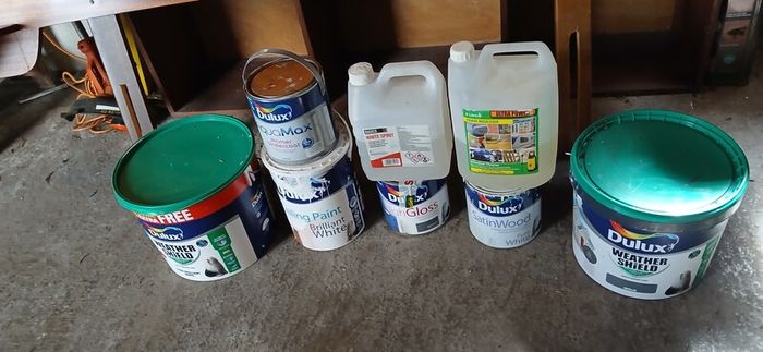 a selection of paint and a paint roller and some good paint brushes