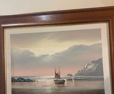 This artwork is a coastal oil painting featuring a traditional single-masted sailing boat stranded or anchored on a calm shoreline, signed by contemporary marine artist David James