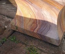 Sandstone garden table and two benches.