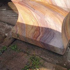 Sandstone garden table and two benches.