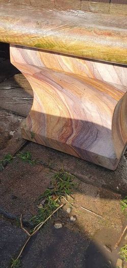 Sandstone garden table and two benches.