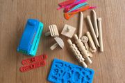 Assorted play doh tools and toys