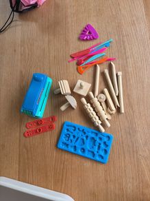 Assorted play doh tools and toys