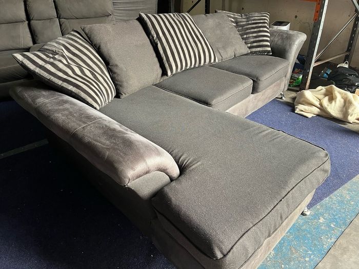 grey/black corner sofa with scatter cushions