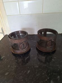 Two rustic pillar candleholders with glass inserts