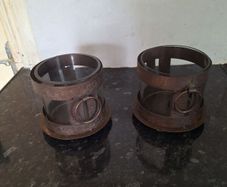 Two rustic pillar candleholders with glass inserts