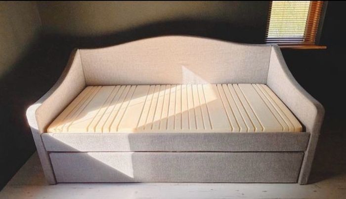 Light grey  upholstered daybed with under-bed storage drawer