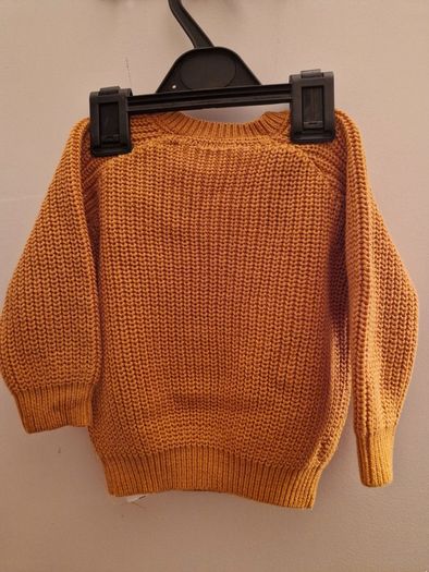 A selection of brand new baby clothes and items