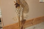 gold-finished, freestanding decorative stand features a clear glass top tray