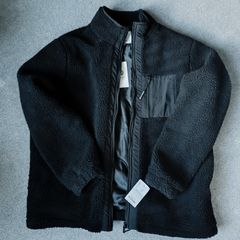 A black fleece jacket with a zipper lining and raincoat inserts. New with tags. Brand: Nordom. Size: XL.