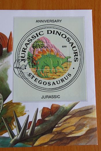 Rare Stegosaurus Dinosaur coin in vintage stamp cover