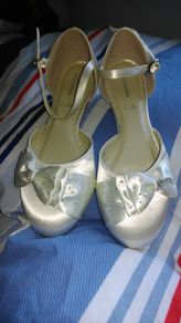 Brand new, never worn ivory satin wedge shoe with satin bow detail.