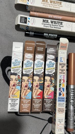 The balm tinted brow gel, clear brow gel, white, black eye pencils, liquid eyeliners