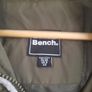 long green coat by bench Image 4
