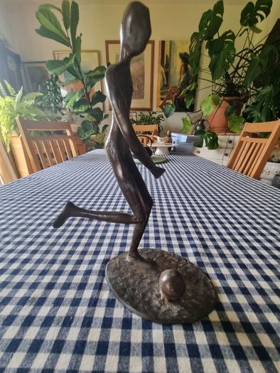 Vintage brass figurine of a football player