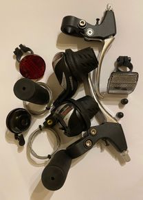 New Shimano Gear Shifters RevoShift SL-RS36-7-LN Twist Grip Shifter for 3 x 7 Speed Mountain bike Includes Gear Cables, Set Black Grips, Aluminium Brake lever, Set Light Reflector, Set Valve Caps and Flick-bell.