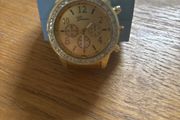 Gold coloured watch with diamonds around the face