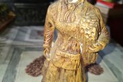 Peasant woman c1950s Wearing a Headscarf and Apron while carrying a bundle of provisions, features detailed facial expressions, textured clothing folds, and a base characteristic of regional decorative collectibles, Postage Available or Collection,