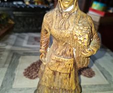 Peasant woman c1950s Wearing a Headscarf and Apron while carrying a bundle of provisions, features detailed facial expressions, textured clothing folds, and a base characteristic of regional decorative collectibles, Postage Available or Collection,