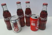 Collection of old Coke Cola Bottles and Cans