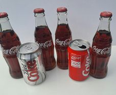 Collection of old Coke Cola Bottles and Cans