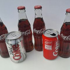 Collection of old Coke Cola Bottles and Cans