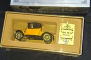 Corgi Collectors Classics 1910 Renault 12/16 scale model car. The set features a 1:43 scale diecast model in a yellow and black color scheme. It comes in its original box with a decorative colored plaque